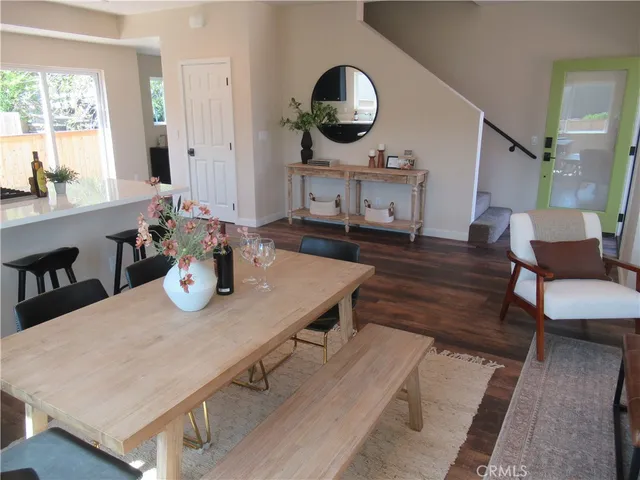 a living room with wooden floor and furniture