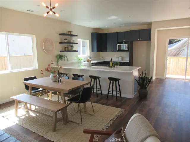 a dining room with furniture and wooden floor