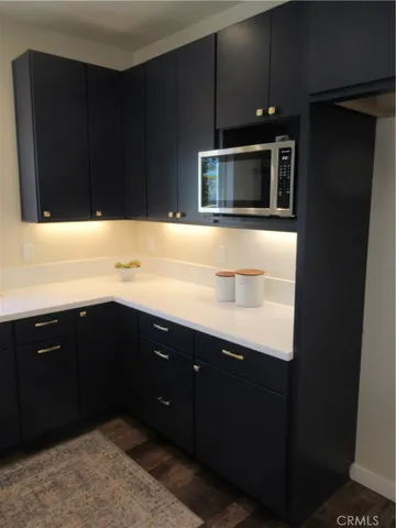 a kitchen with kitchen island a sink appliances and cabinets