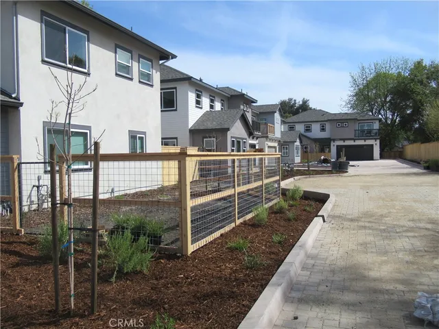 a view of a house with wooden fence