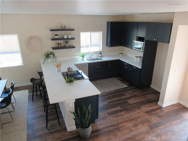 a kitchen with a table chairs refrigerator and microwave