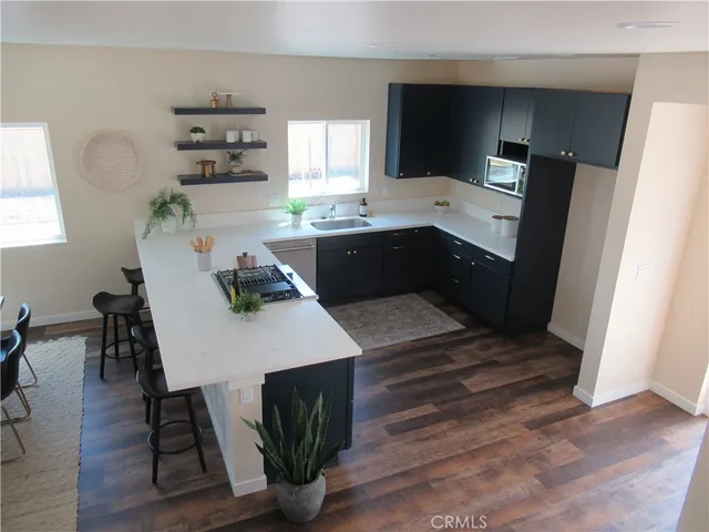 a kitchen with a table chairs refrigerator and microwave