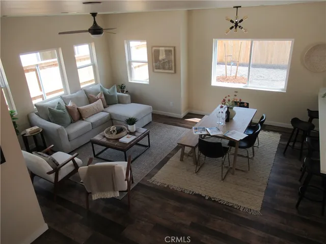 a living room with furniture wooden floor and a window