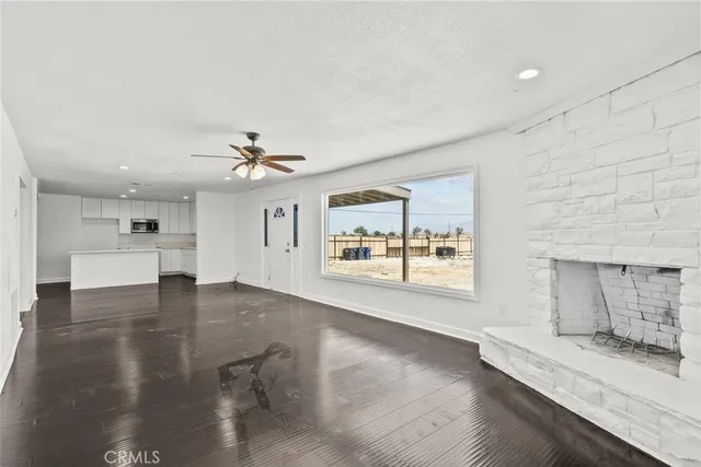 a view of a livingroom with a ceiling fan and window