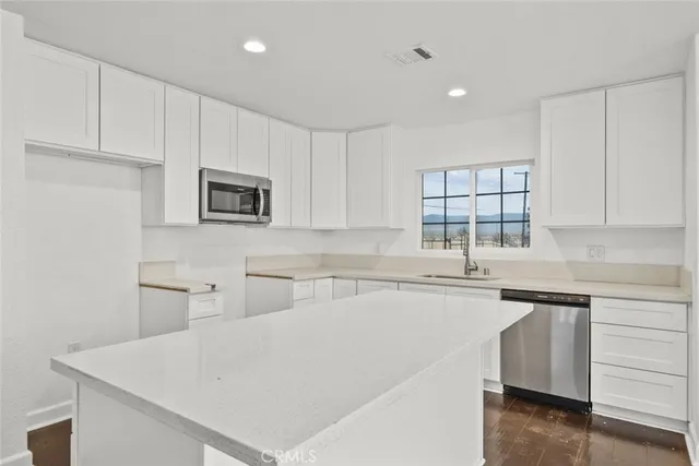 a kitchen with a sink a stove and cabinets