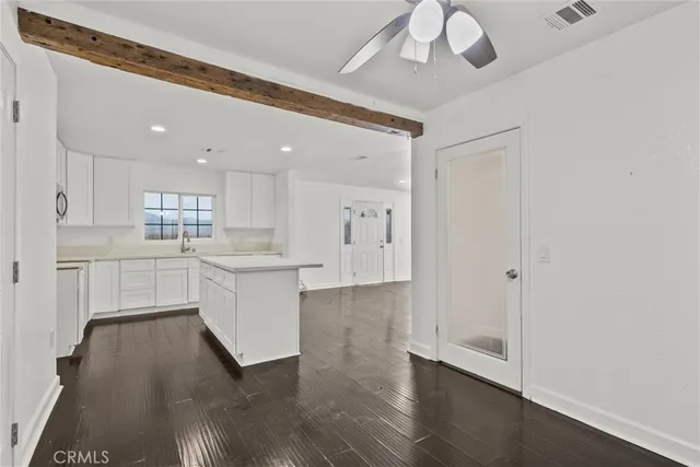 a large white kitchen with a white cabinet and a stove top oven