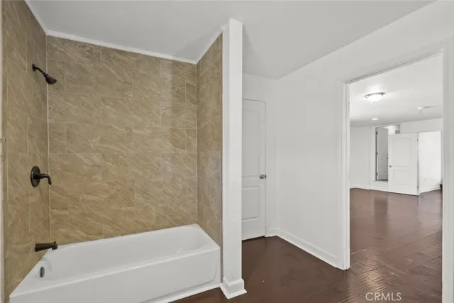 a bathroom with a bathtub and a shower