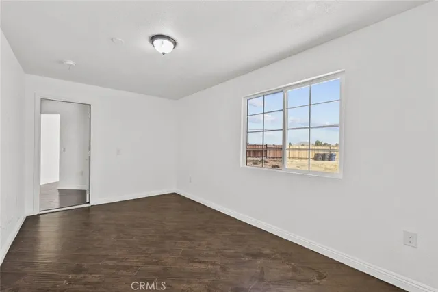 an empty room with a empty space and windows