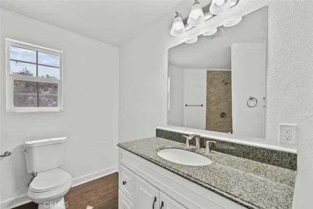 a bathroom with a granite countertop bathtub shower sink and mirror