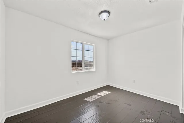 an empty room with wooden floor
