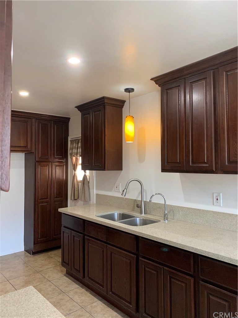 8216 Wilbarn Street Paramount, CA 90723 - Photo 11 of 27 a bathroom with a double vanity sink and a large mirror