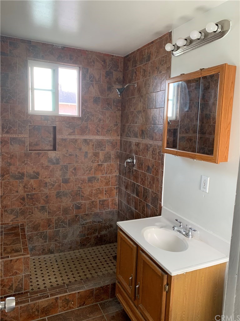 8216 Wilbarn Street Paramount, CA 90723 - Photo 19 of 27 a bathroom with a sink and a mirror