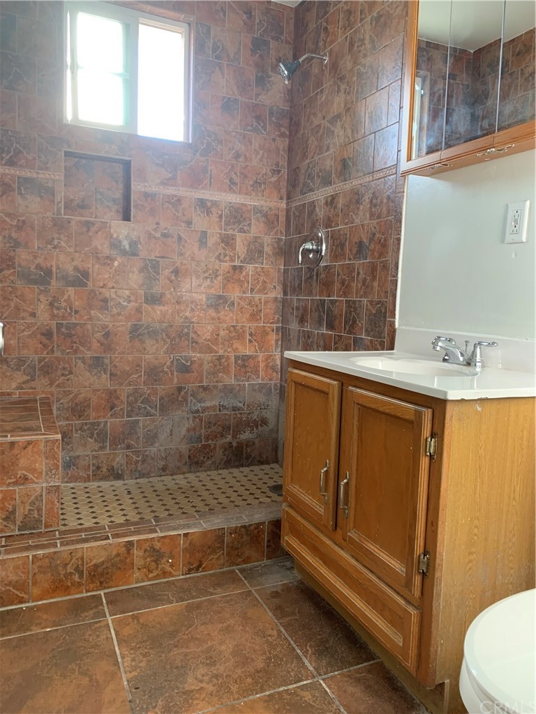 8216 Wilbarn Street Paramount, CA 90723 - Photo 21 of 27 a bathroom with a sink a toilet and shower
