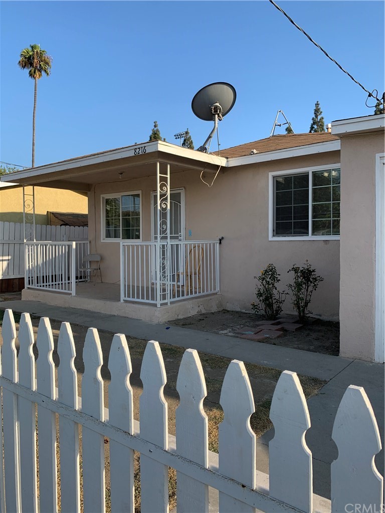 8216 Wilbarn Street Paramount, CA 90723 - Photo 3 of 27 a front view of a house with garden