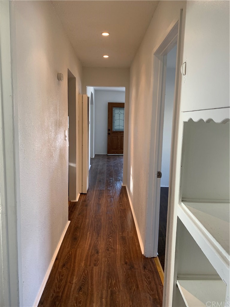 8216 Wilbarn Street Paramount, CA 90723 - Photo 7 of 27 a view of a hallway with wooden floor and staircase