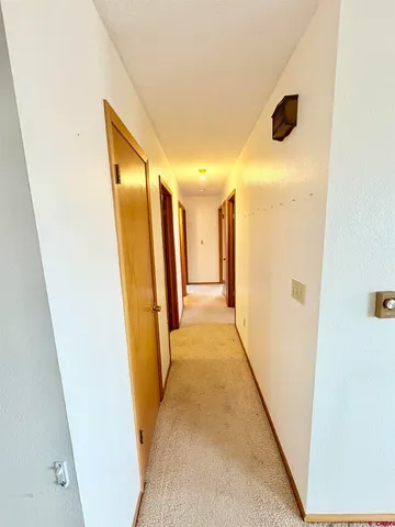 a view of hallway with stainless steel appliances