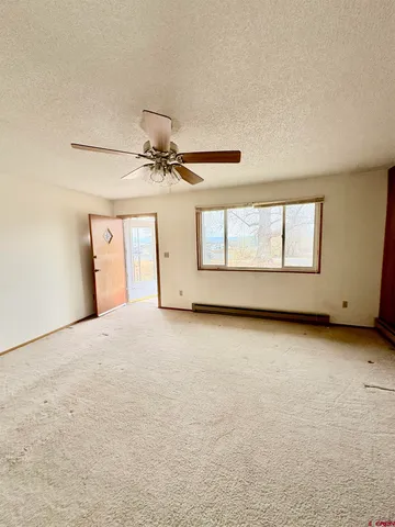 a view of a livingroom with a dishwasher and a window