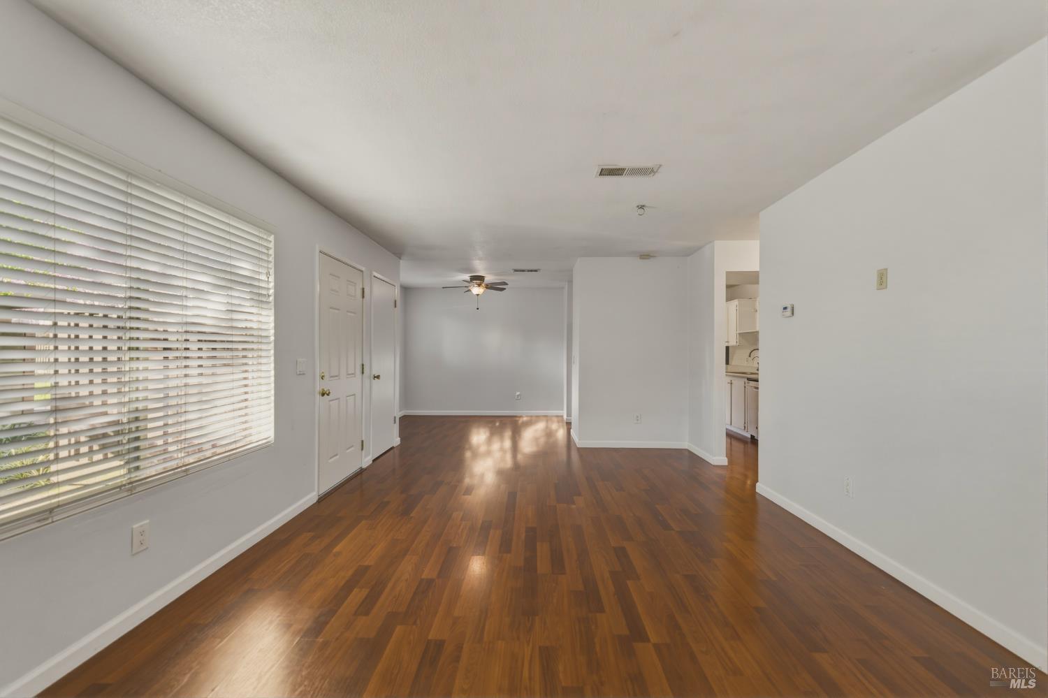 1741 Las Raposas Court Santa Rosa, CA 95409 - Photo 11 of 27 a view of an empty room with wooden floor and a window