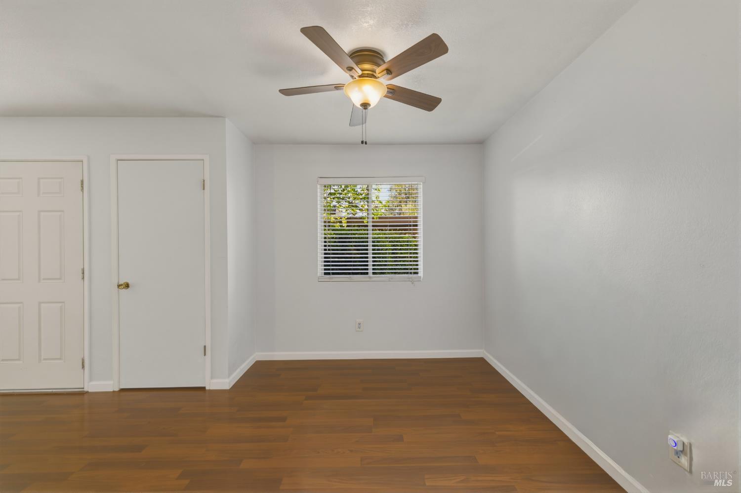1741 Las Raposas Court Santa Rosa, CA 95409 - Photo 12 of 27 wooden floor in an empty room with a window