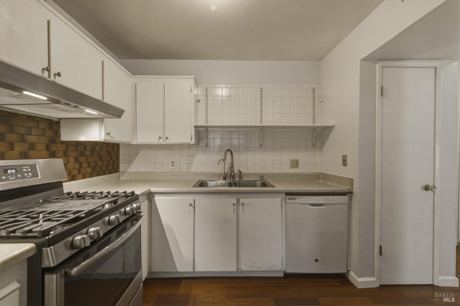 1741 Las Raposas Court Santa Rosa, CA 95409 - Photo 14 of 27 a kitchen with stainless steel appliances a sink stove and cabinets