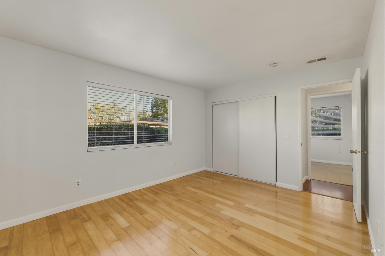 1741 Las Raposas Court Santa Rosa, CA 95409 - Photo 22 of 27 a view of an empty room with wooden floor and a window