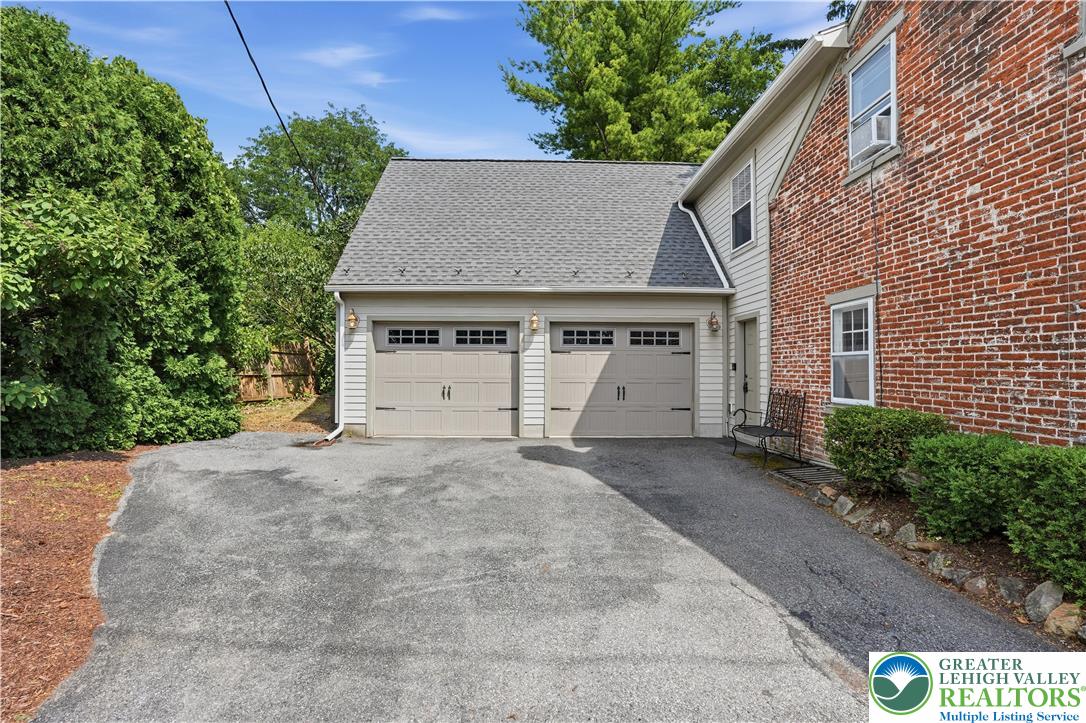 2014 Linden Street Bethlehem, PA 18017 - Photo 77 of 85 A classic brick exterior meets modern convenience with a two-car garage and paved driveway.