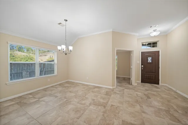 a view of empty room with a kitchen