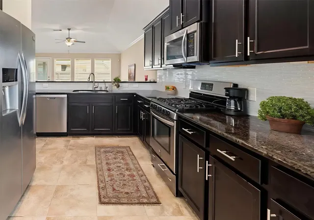 a view of a living room kitchen and a sink