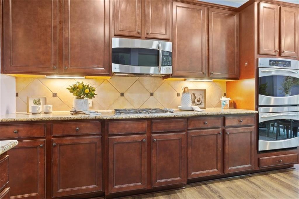 211 Parc Drive Canton, GA 30114 - Photo 16 of 62 a kitchen with granite countertop wooden cabinets and a sink
