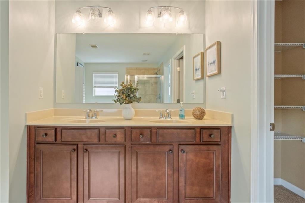 211 Parc Drive Canton, GA 30114 - Photo 29 of 62 a spacious bathroom with a double vanity sink and a mirror