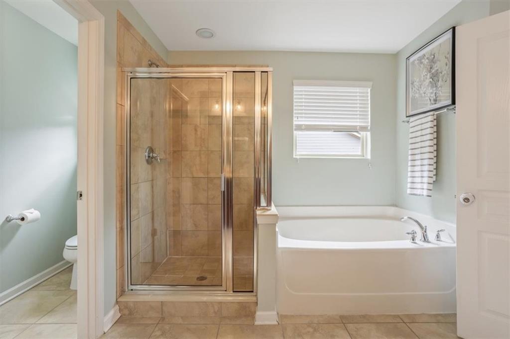 211 Parc Drive Canton, GA 30114 - Photo 30 of 62 a bathroom with a bathtub and a shower