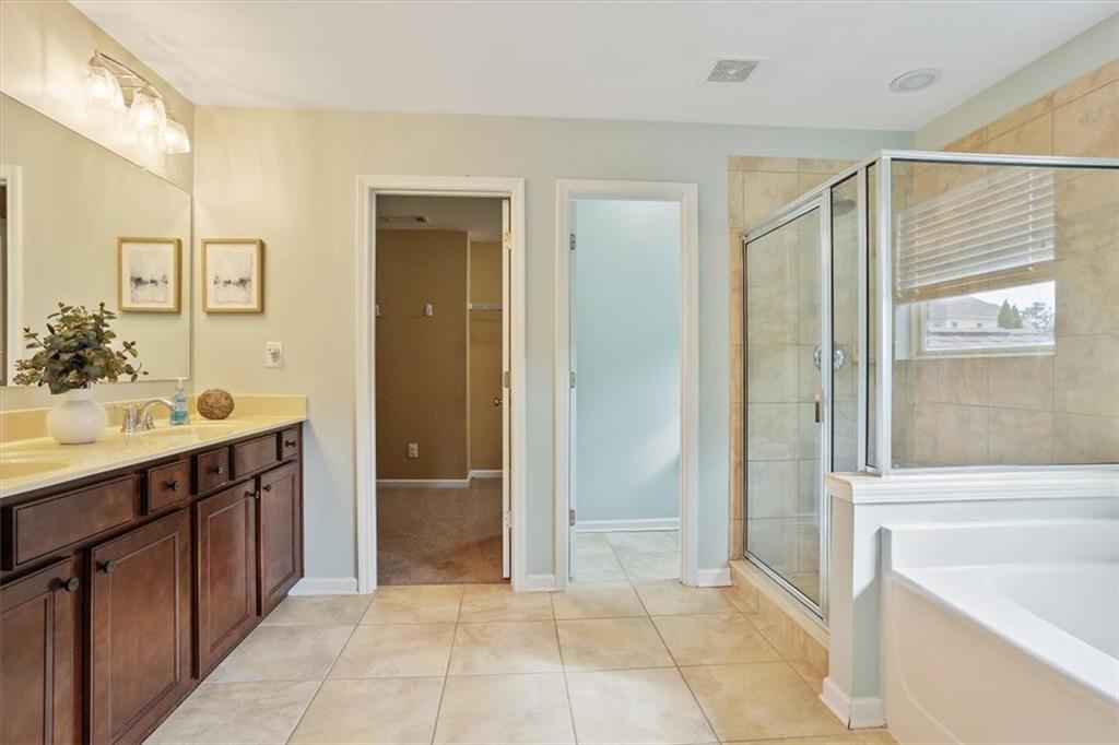 211 Parc Drive Canton, GA 30114 - Photo 32 of 62 a bathroom with a shower sink and mirror