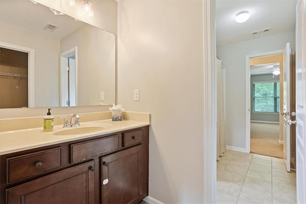 211 Parc Drive Canton, GA 30114 - Photo 37 of 62 a bathroom with a double vanity sink and a mirror