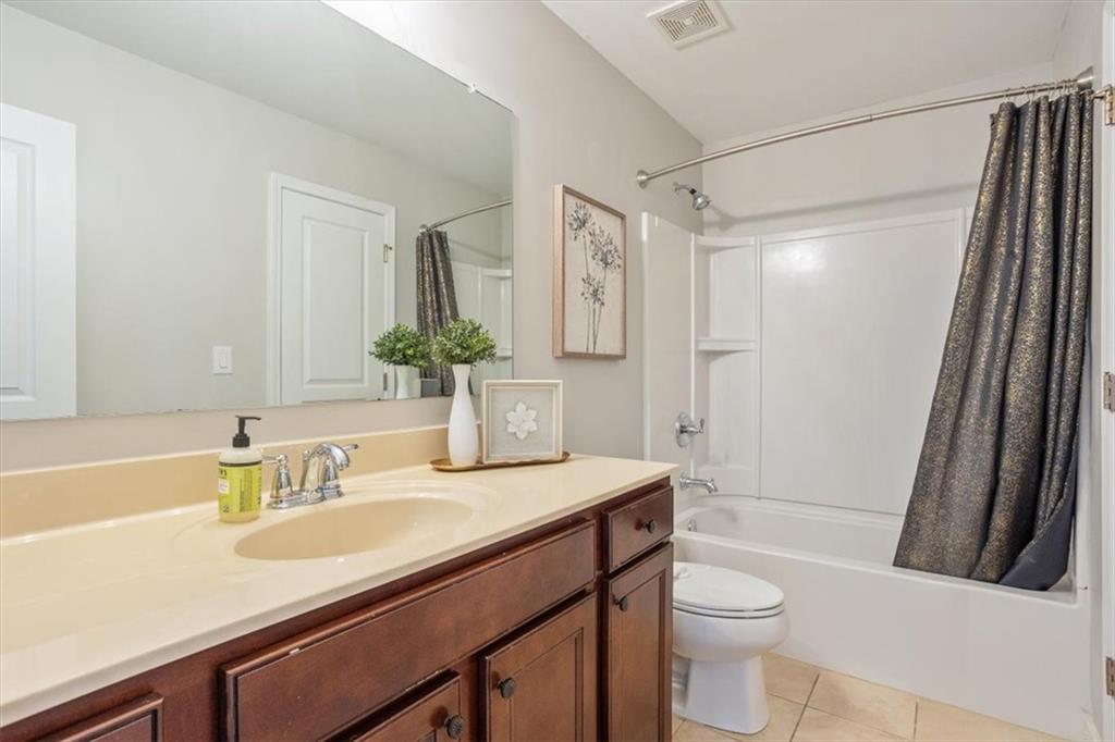 211 Parc Drive Canton, GA 30114 - Photo 41 of 62 a bathroom with a sink a toilet a mirror a vanity and shower