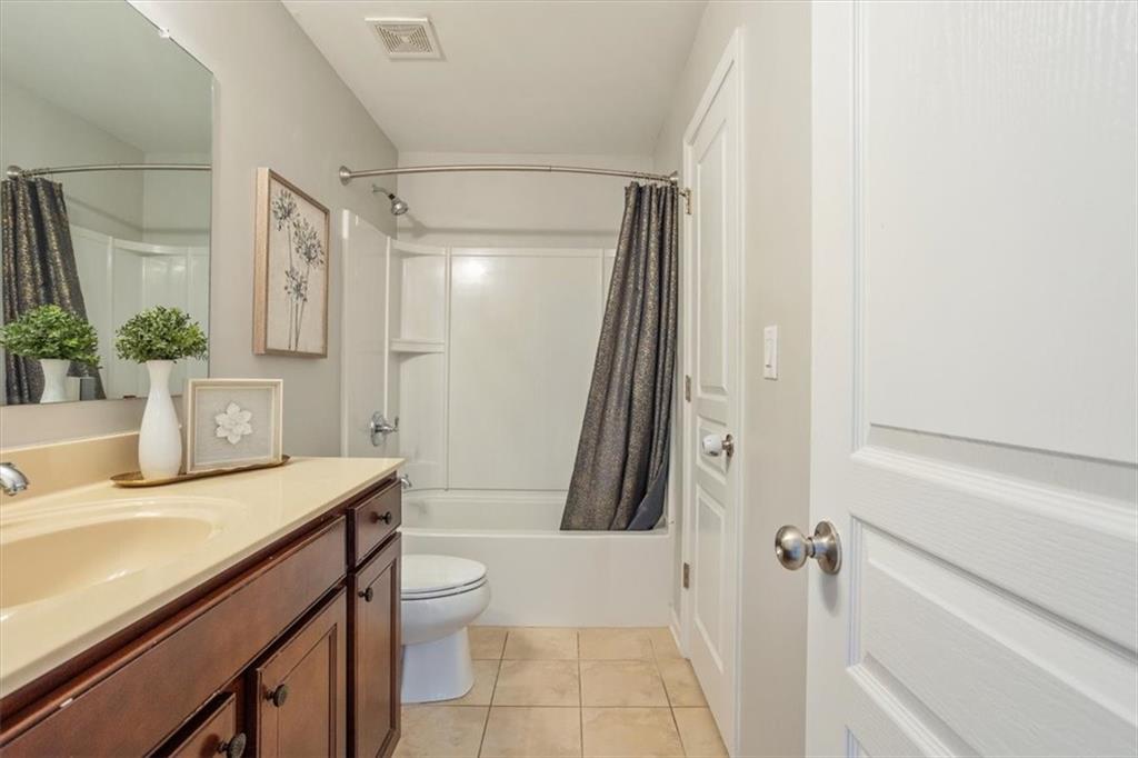 211 Parc Drive Canton, GA 30114 - Photo 42 of 62 a bathroom with a sink a toilet a mirror and shower