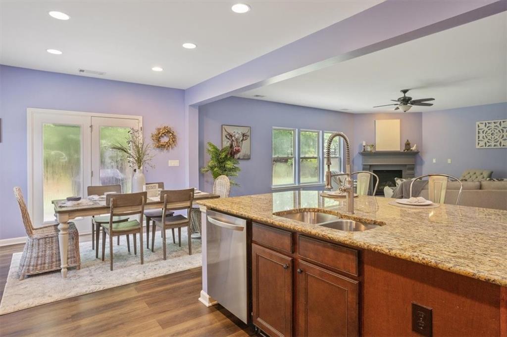 211 Parc Drive Canton, GA 30114 - Photo 5 of 62 a dining hall with stainless steel appliances granite countertop a kitchen island a stove a table and chairs
