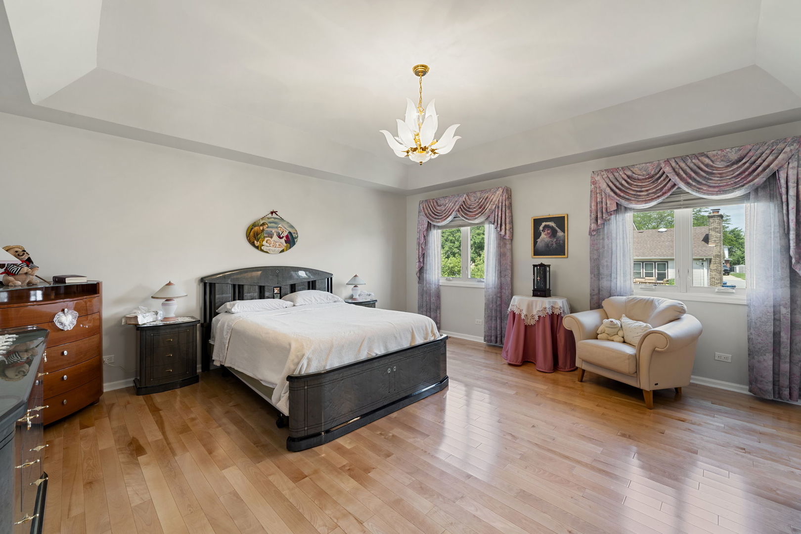 1520 Grove Drive Addison, IL 60101 - Photo 16 of 43 a bedroom with a bed and a chandelier