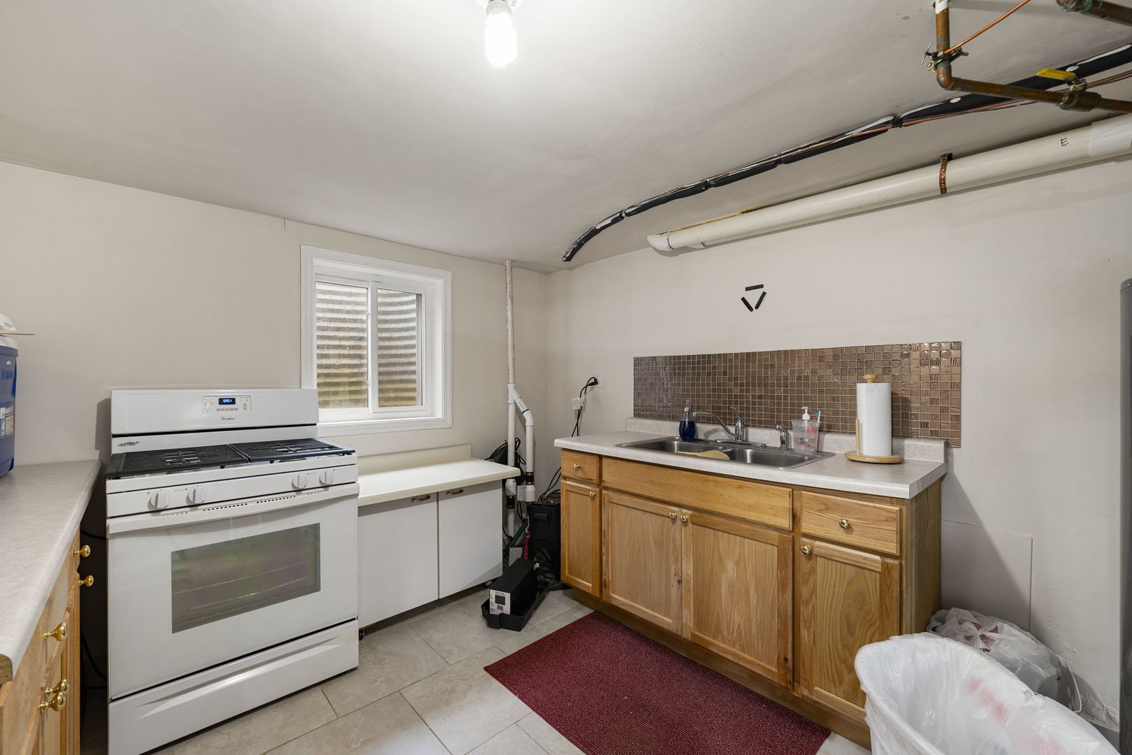 1520 Grove Drive Addison, IL 60101 - Photo 30 of 43 a kitchen with a stove sink and cabinets