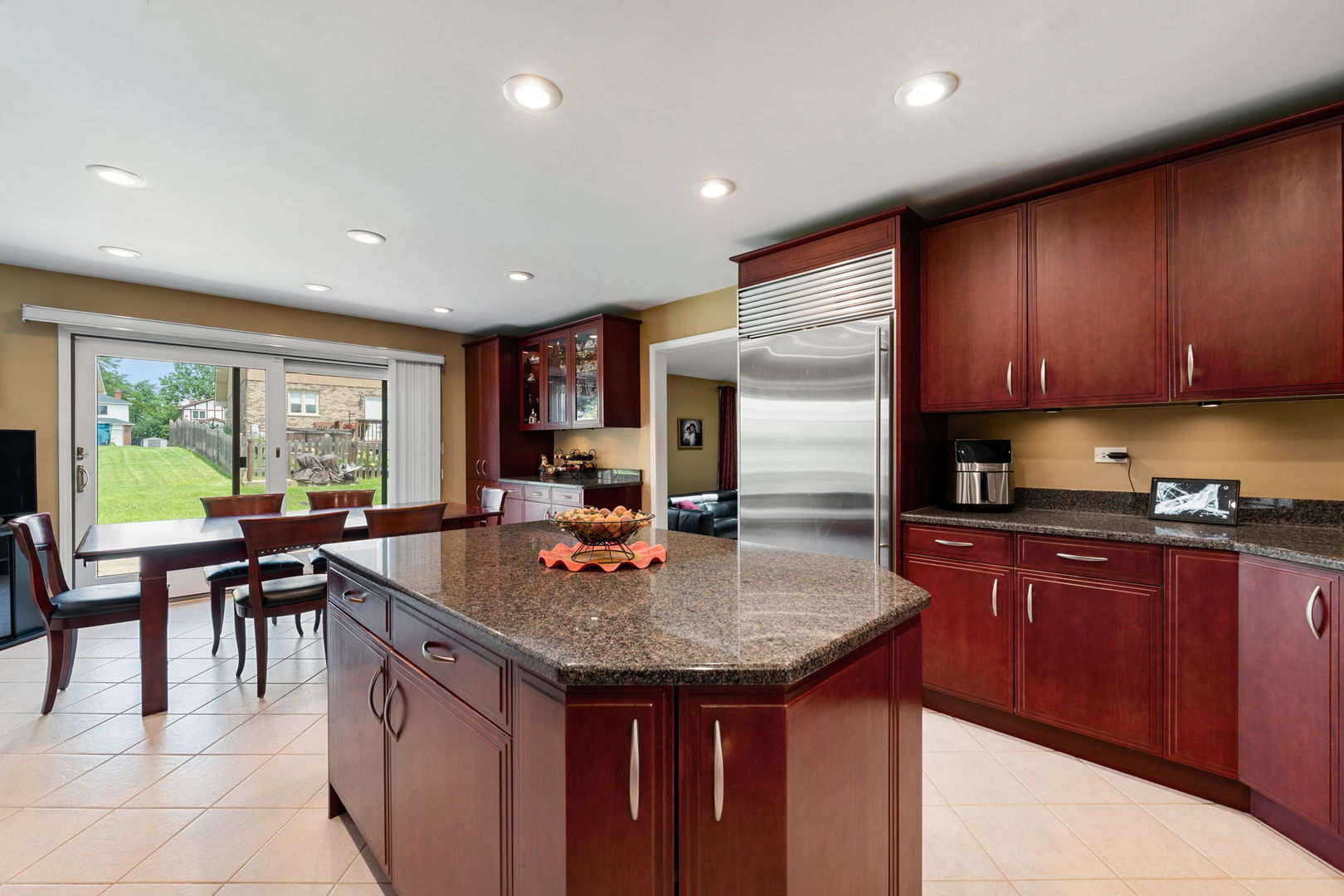 1520 Grove Drive Addison, IL 60101 - Photo 4 of 43 a kitchen with granite countertop kitchen island stainless steel appliances a table and chairs in it