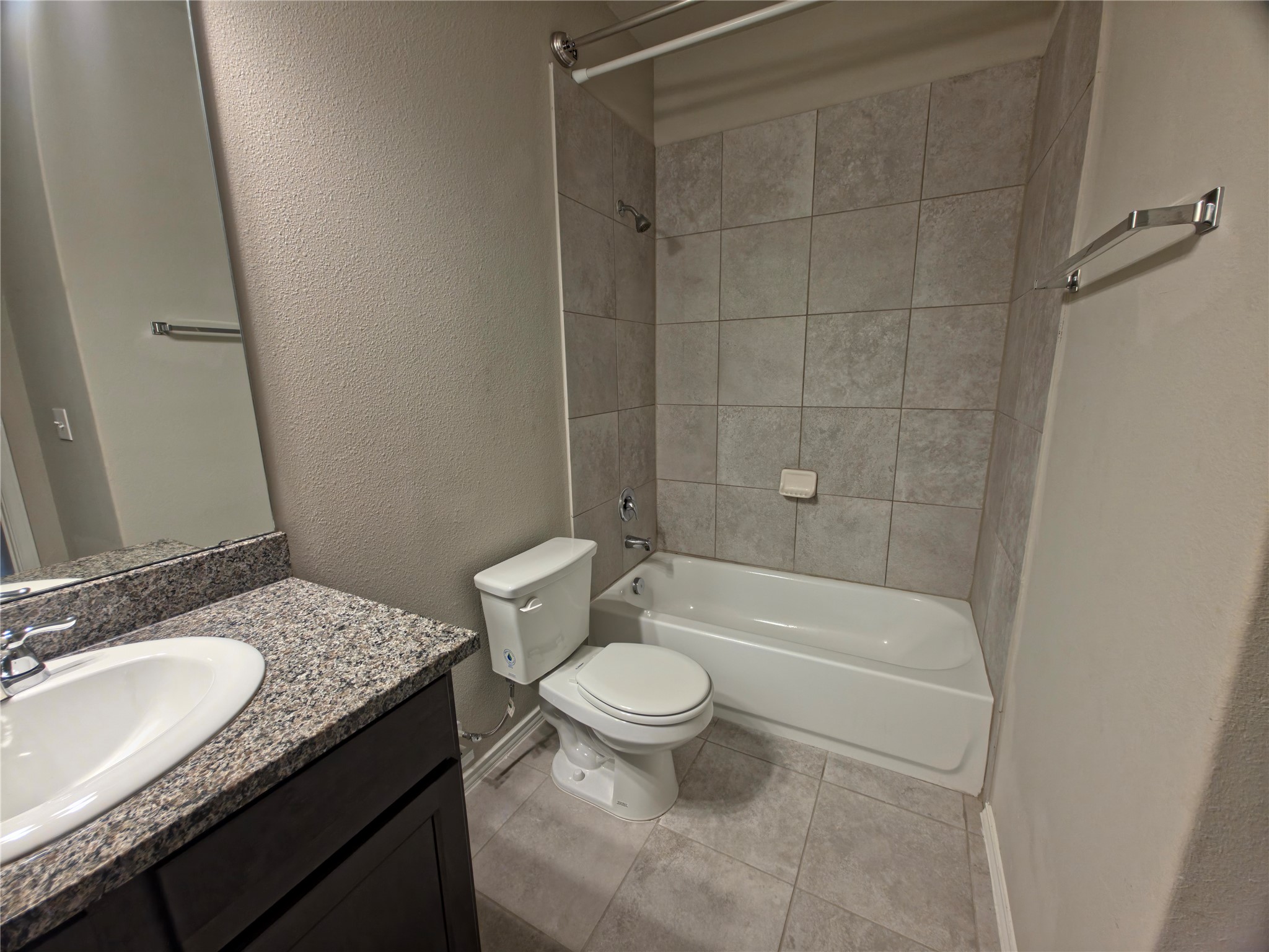 140 Dodge Road Georgetown, TX 78626 - Photo 12 of 14 Full bathroom featuring a dark wood-finish vanity with a granite-style countertop, an undermount sink, and a framed mirror