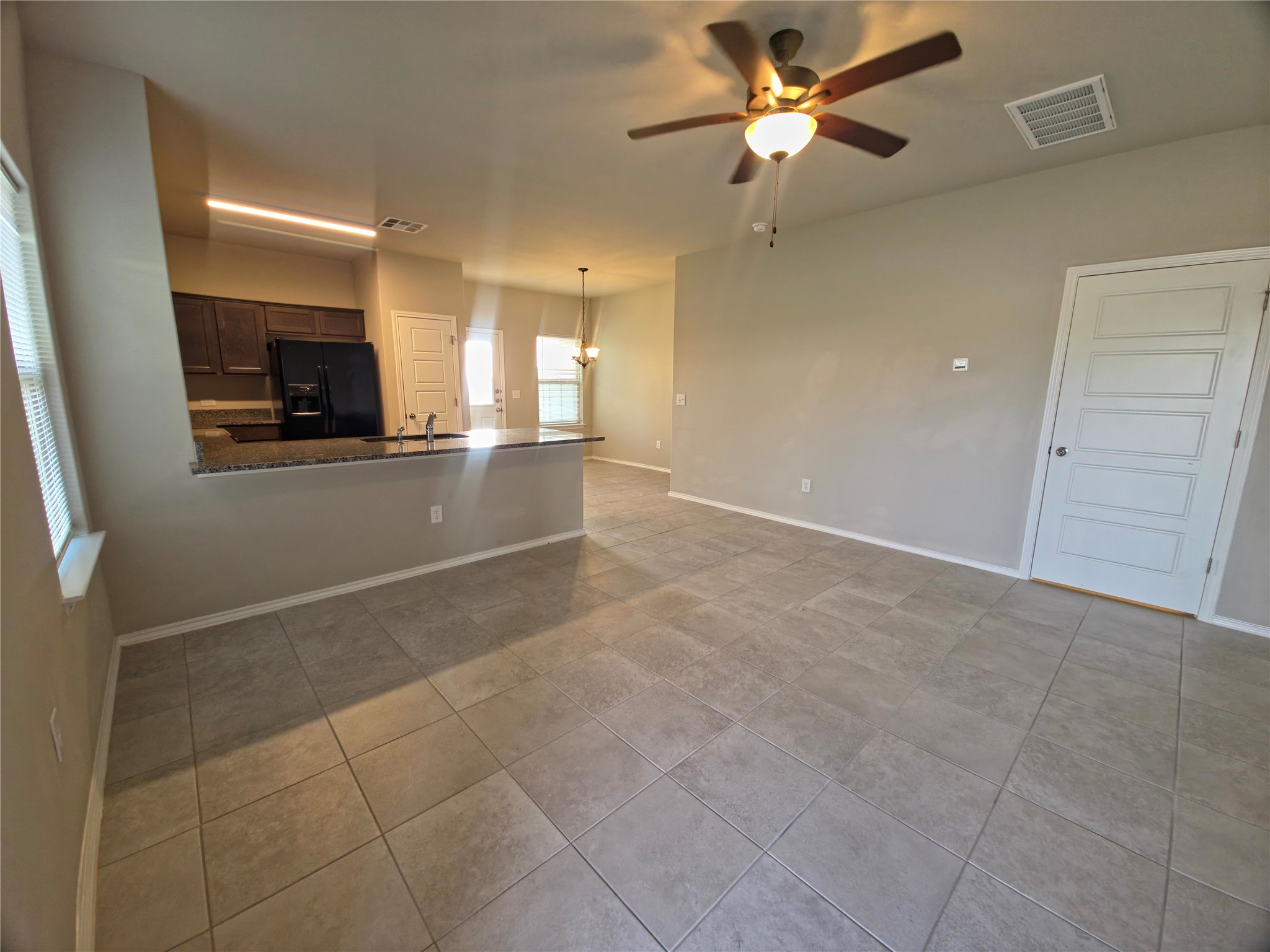 140 Dodge Road Georgetown, TX 78626 - Photo 4 of 14 Open-concept living area featuring large format tile flooring and a ceiling fan with integrated lighting