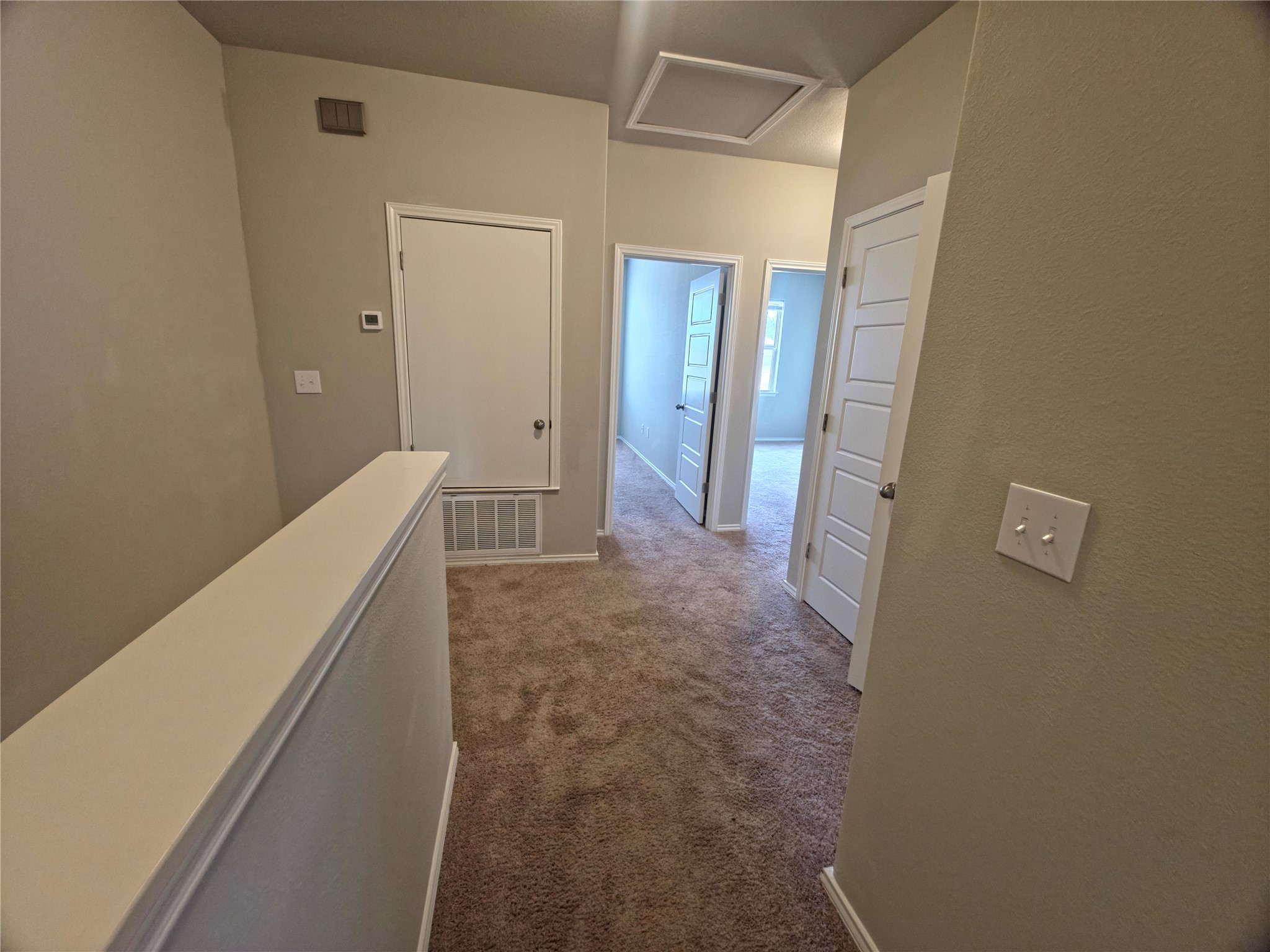 140 Dodge Road Georgetown, TX 78626 - Photo 8 of 14 Carpeted hallway with light neutral wall paint and white trim