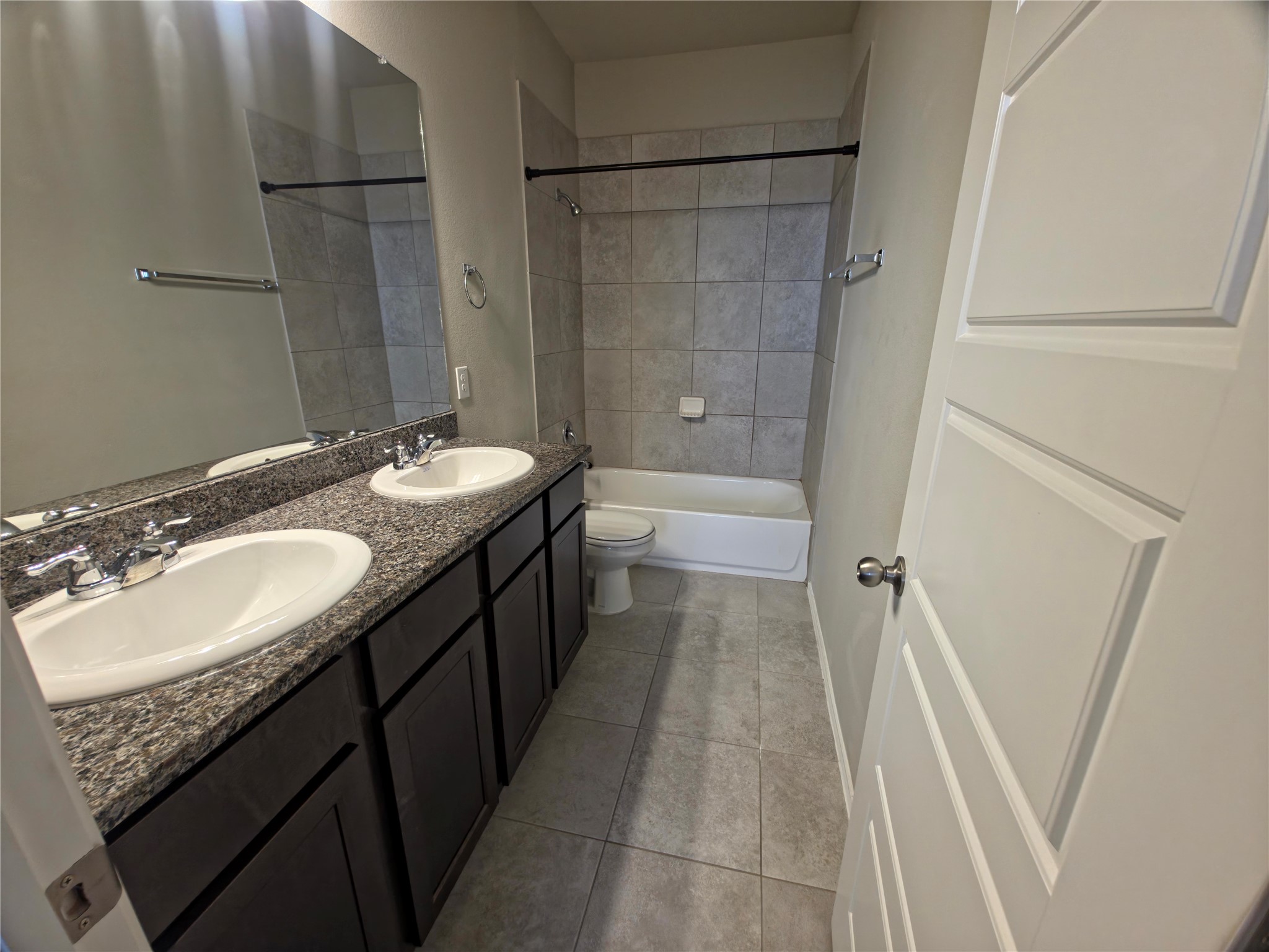 140 Dodge Road Georgetown, TX 78626 - Photo 9 of 14 Dual vanity with integrated sinks, speckled countertop, and dark wood-finish cabinetry