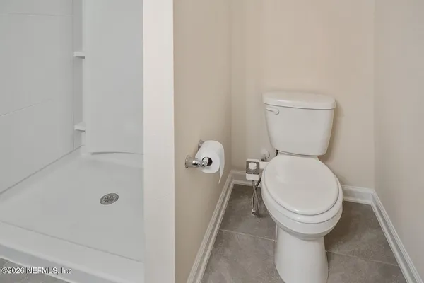 a view of a room with an empty space and a hallway