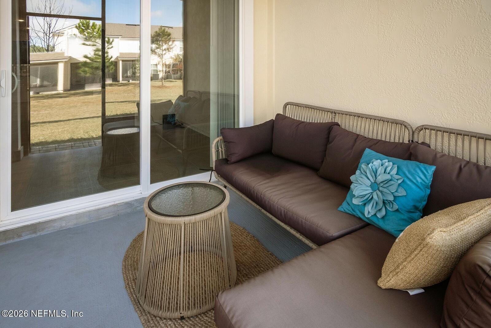 73 Java Lane St. Augustine, FL 32092 - Photo 6 of 18 a living room with furniture and a floor to ceiling window