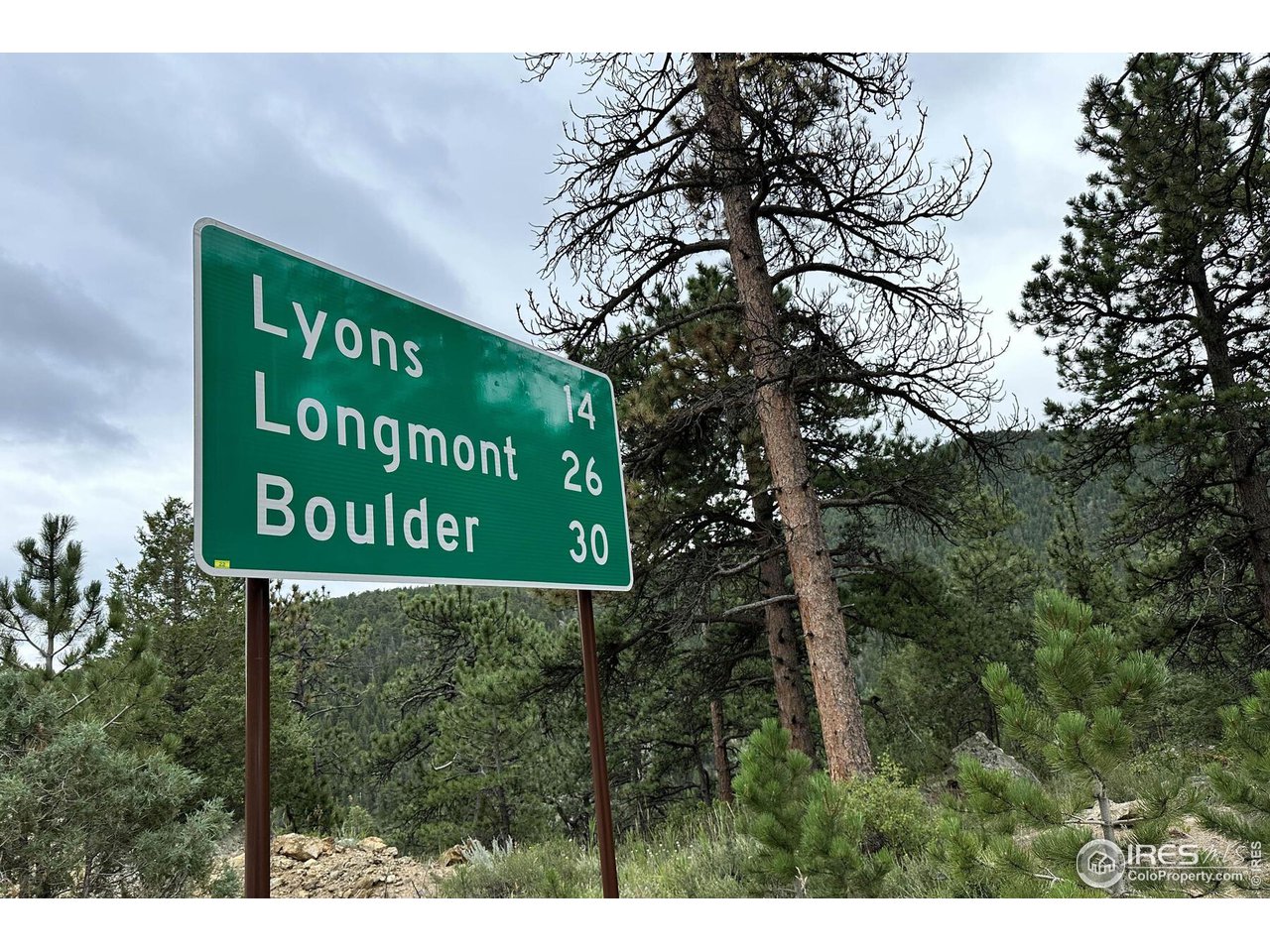 2159 Riverside Drive Lyons, CO 80540 - Photo 14 of 21 a sign broad in front of the red white house