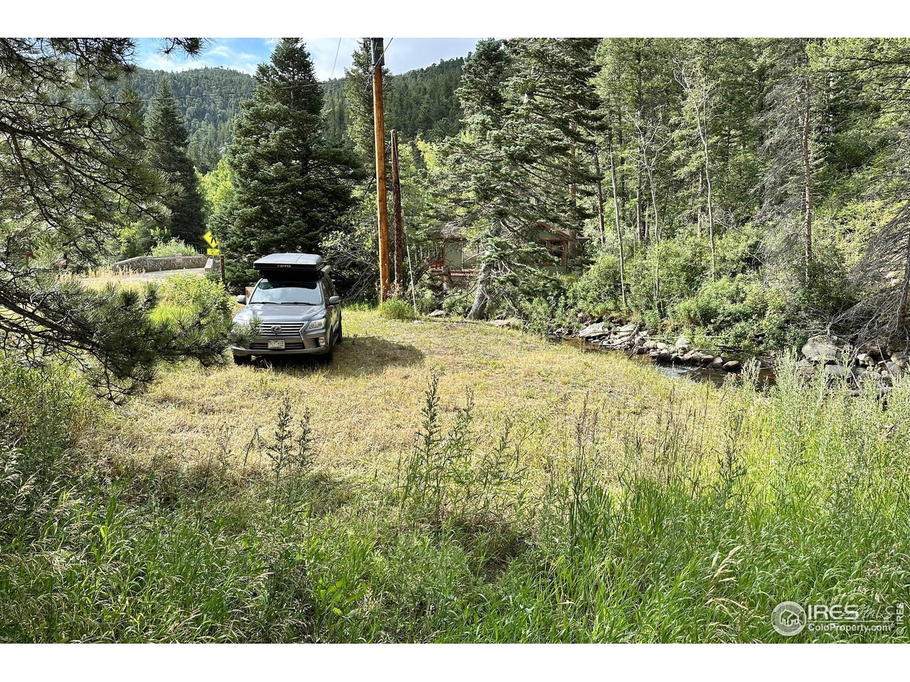 2159 Riverside Drive Lyons, CO 80540 - Photo 2 of 21 a backyard of a house with barbeque oven