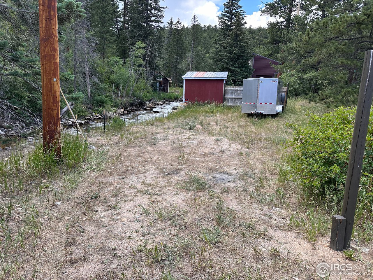 2159 Riverside Drive Lyons, CO 80540 - Photo 21 of 21 a view of house with yard and trees in the background