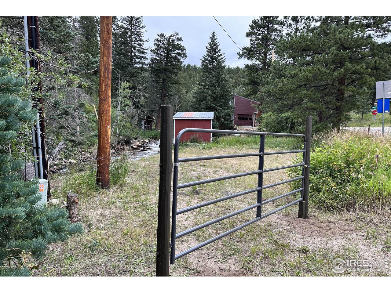 2159 Riverside Drive Lyons, CO 80540 - Photo 8 of 21 a view of a wooden fence and trees