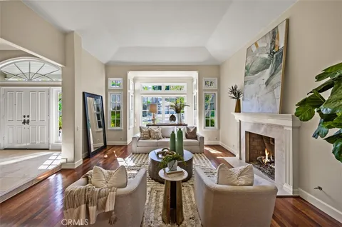 a living room with furniture a rug and a book shelf